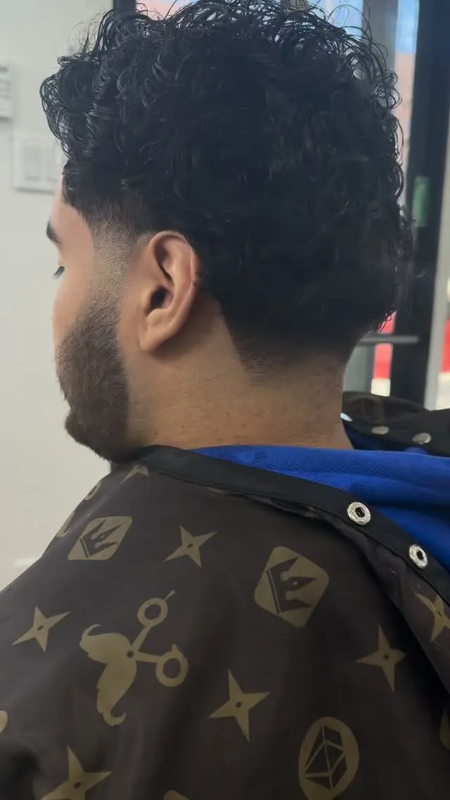 Taper fade with curly top, side view